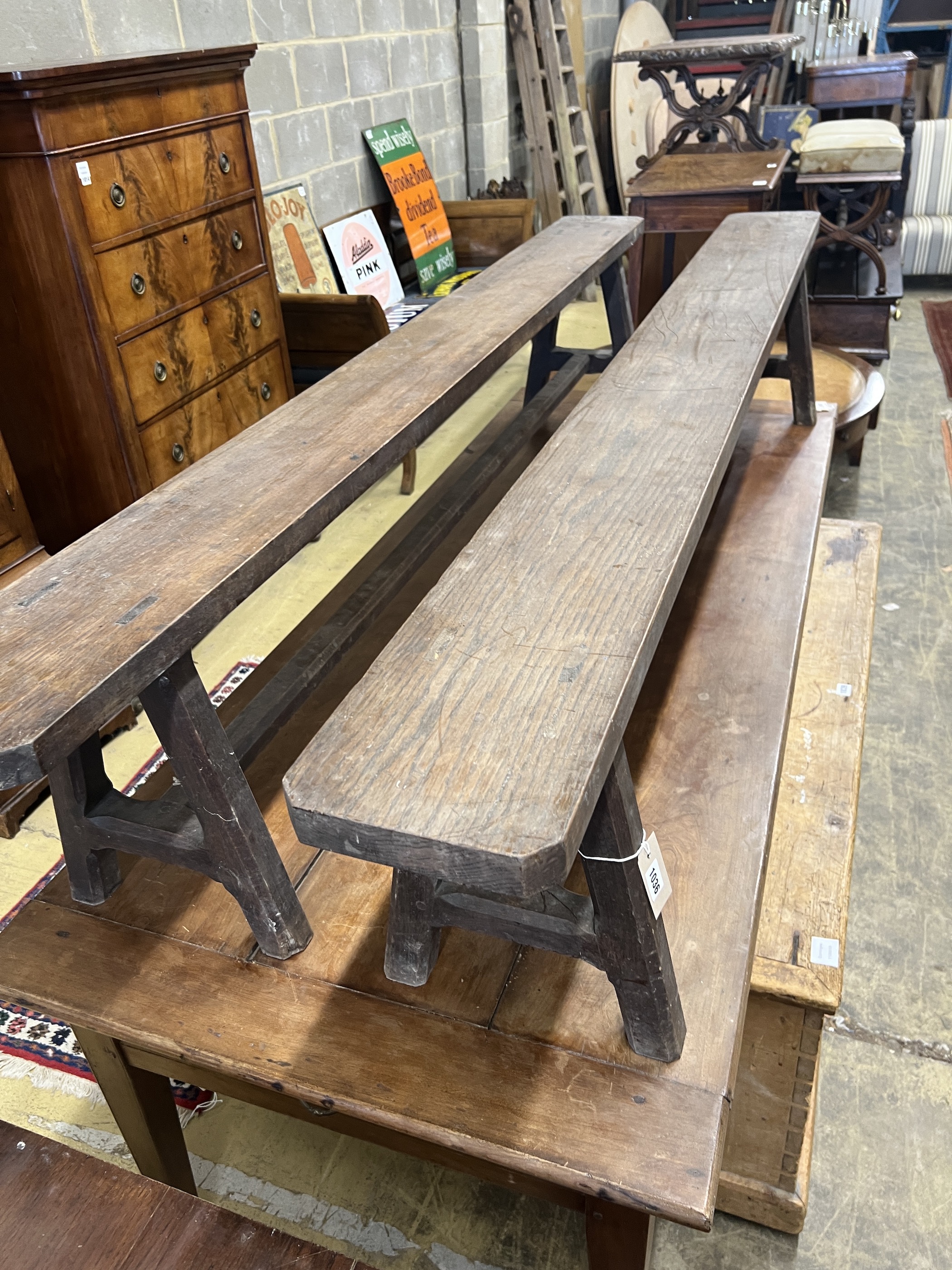 A pair of late 19th century French oak benches, length 210cm, depth 20cm, height 42cm